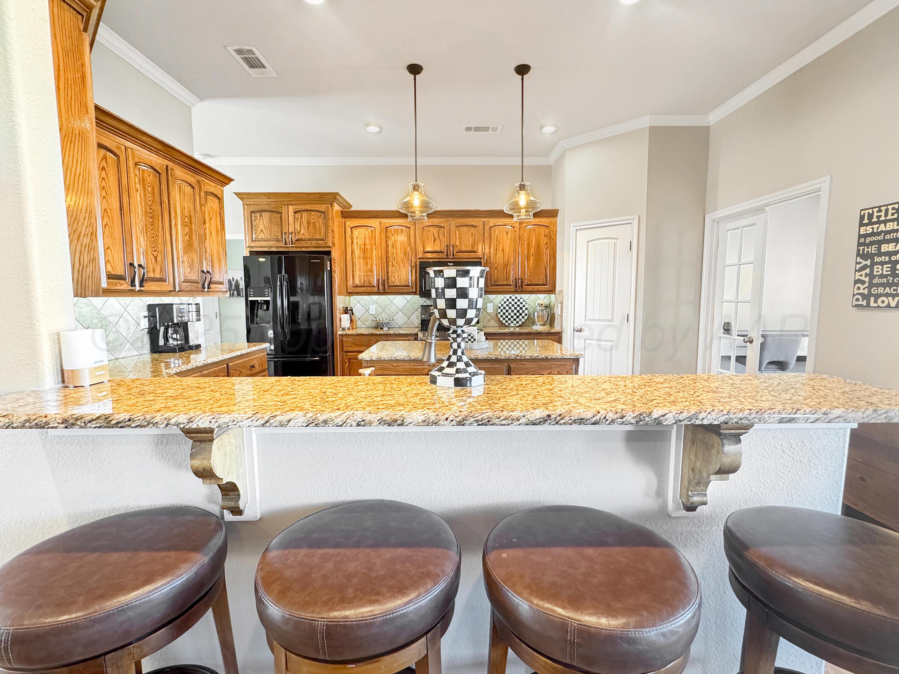 18500 Morning Star Road Bushland, TX 79124 - Photo 13 of 47 a kitchen with a table chairs stove and kitchen island
