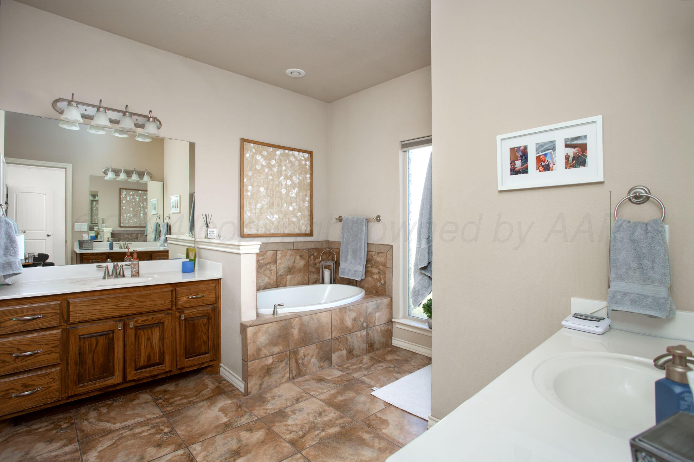 18500 Morning Star Road Bushland, TX 79124 - Photo 21 of 47 a spacious bathroom with a tub sink and mirror