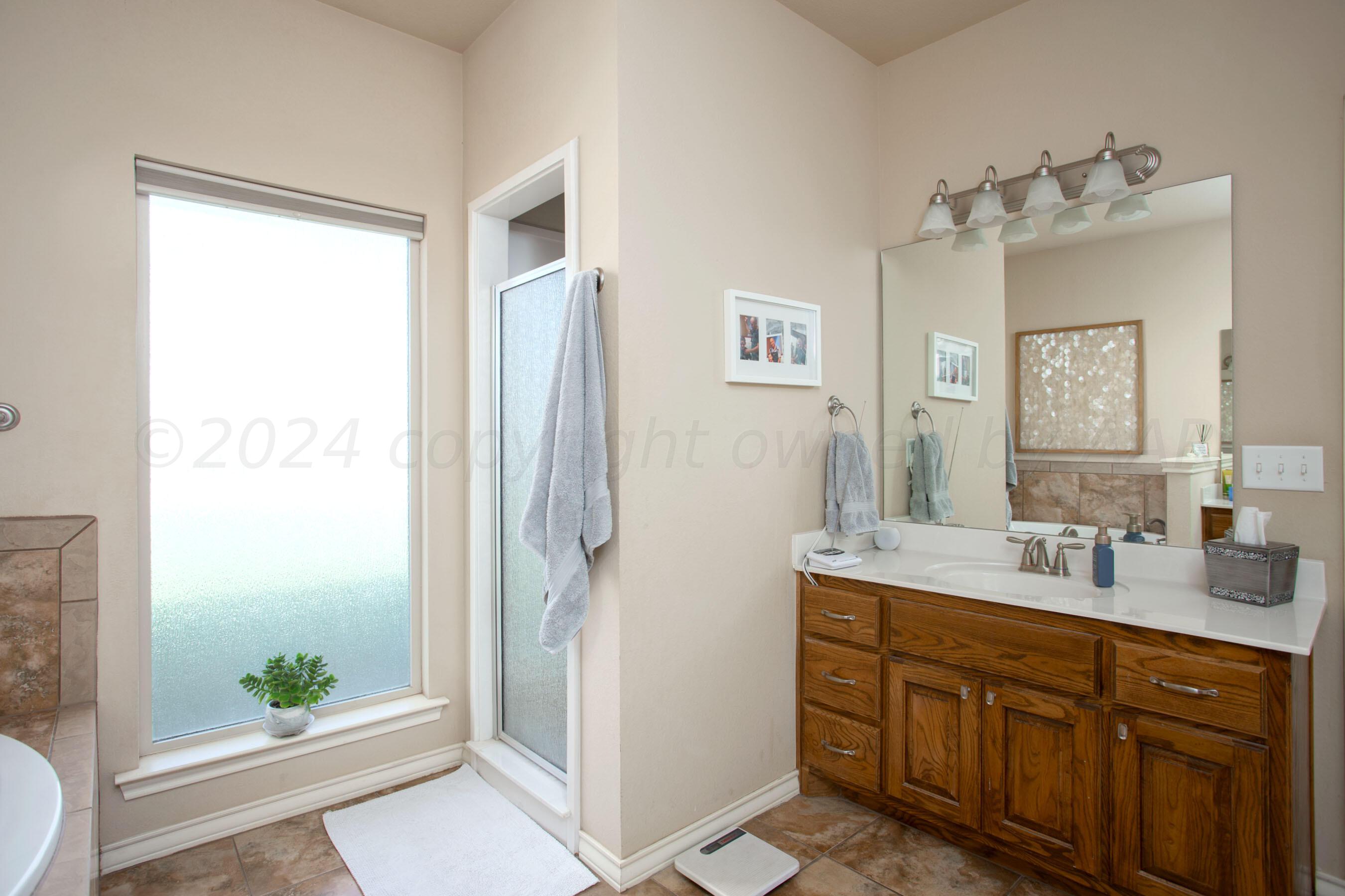 18500 Morning Star Road Bushland, TX 79124 - Photo 22 of 47 a spacious bathroom with a double vanity sink and a mirror