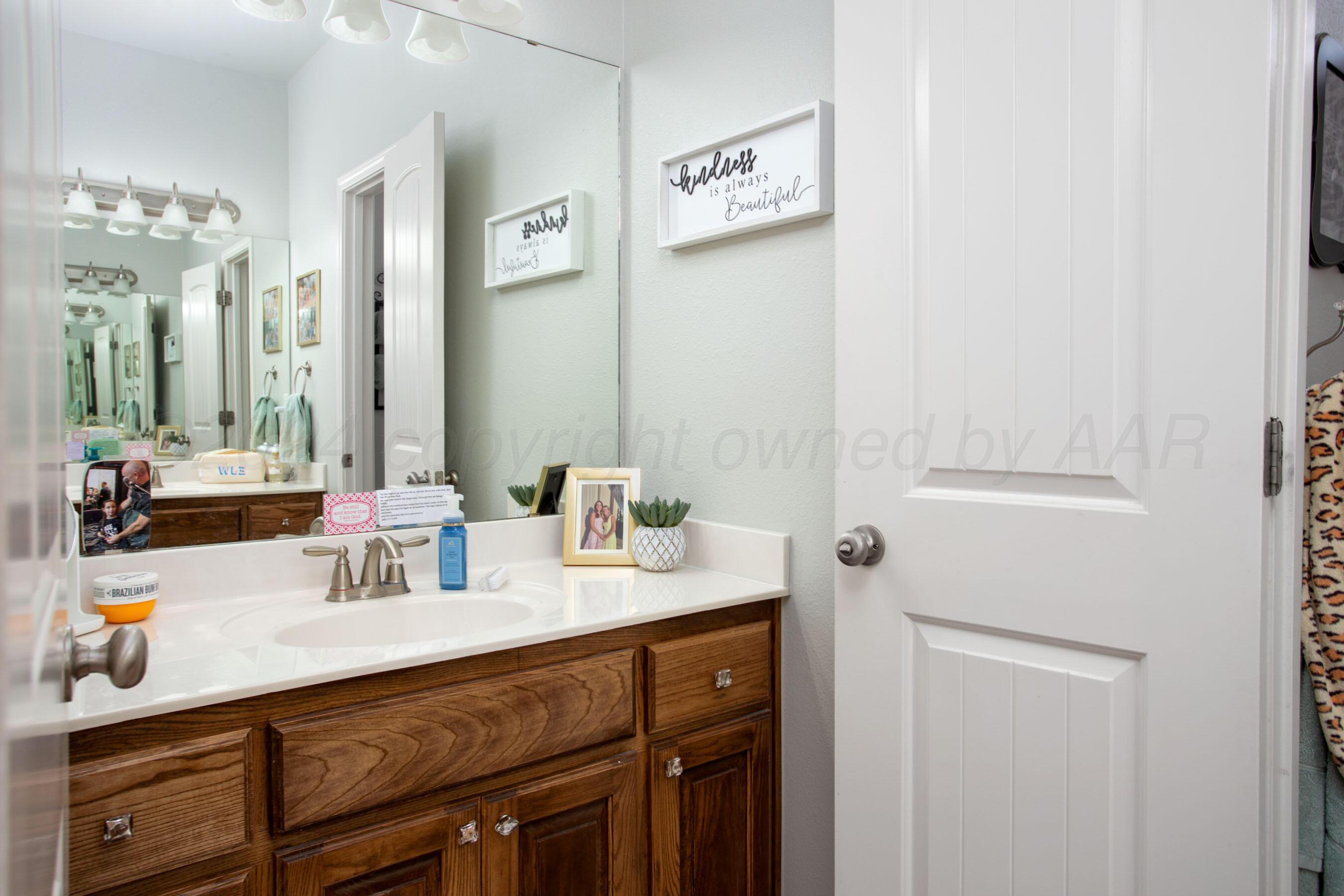 18500 Morning Star Road Bushland, TX 79124 - Photo 29 of 47 a bathroom with a sink and a mirror