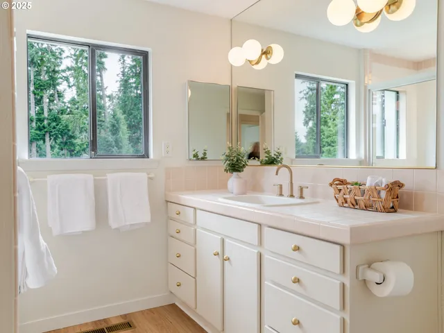 a bathroom with a double vanity sink and a mirror