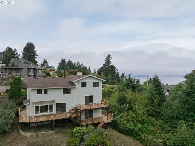 an aerial view of a house with a yard and balcony