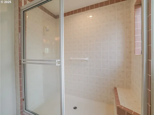a bathroom with a glass shower door