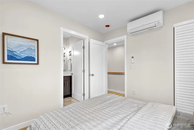 a view of a bedroom with wooden floor