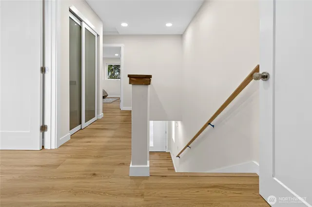 a view of entryway and hall with wooden floor