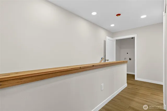 a big room with wooden floor and natural light
