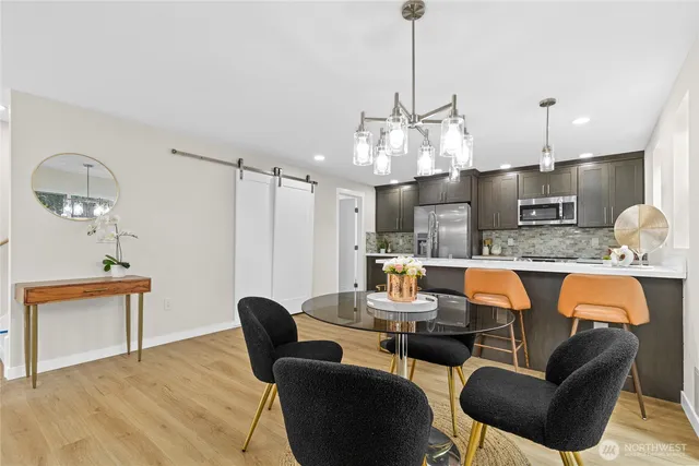 a dining room with furniture a lamp and a chandelier