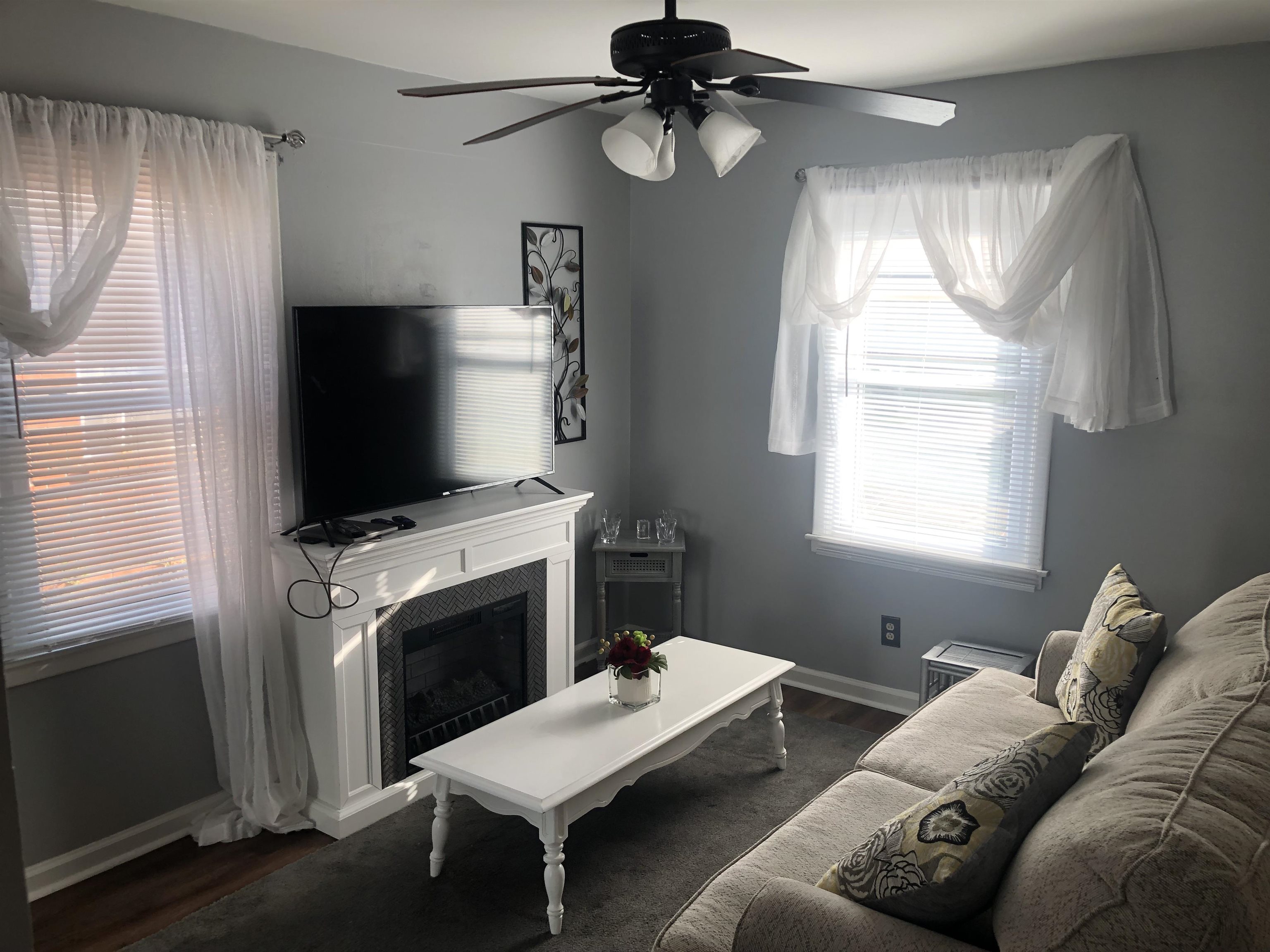 1563 Railton Road Memphis, TN 38111 - Photo 8 of 17 Living room with a ceiling fan, a fireplace, and dark wood-style floors
