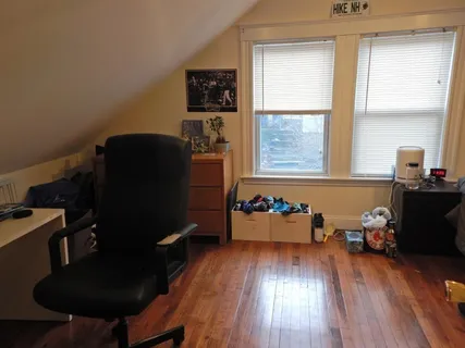 a bedroom with furniture and a window