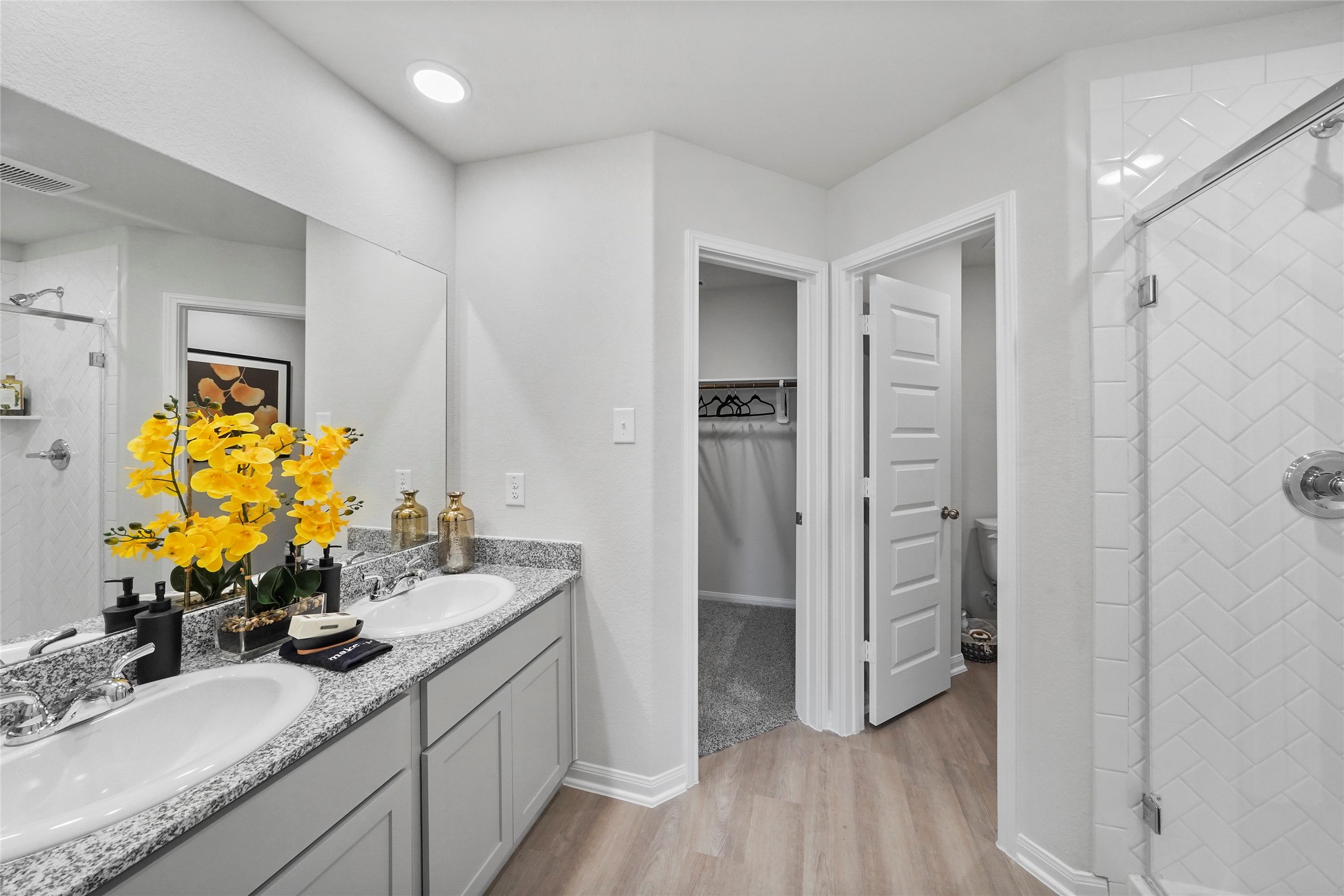 18782 Lucas Michael Way New Caney, TX 77357 - Photo 12 of 16 a bathroom with a double vanity sink mirror and shower
