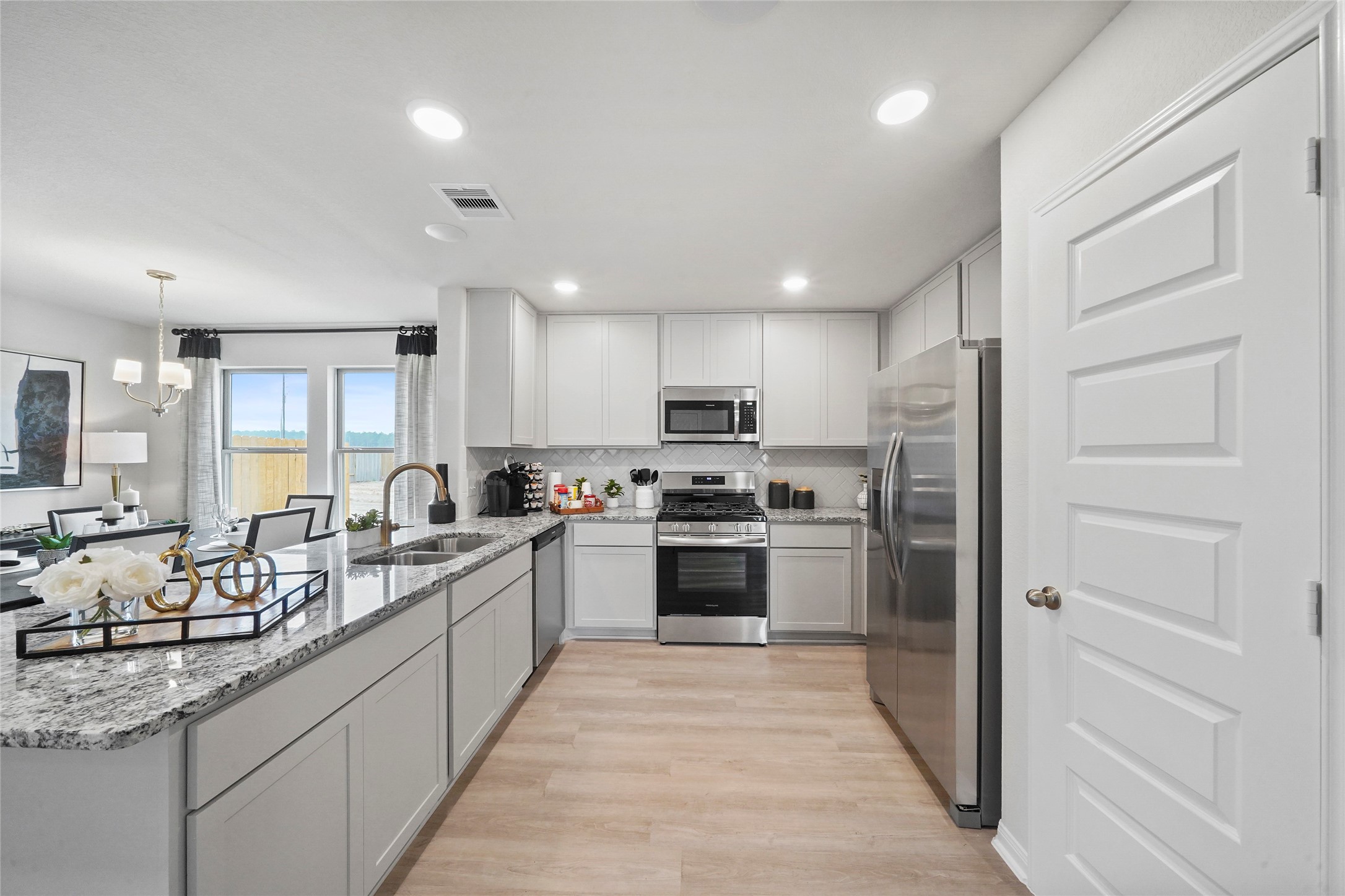 18782 Lucas Michael Way New Caney, TX 77357 - Photo 6 of 16 a large kitchen with stainless steel appliances lots of counter space and a sink