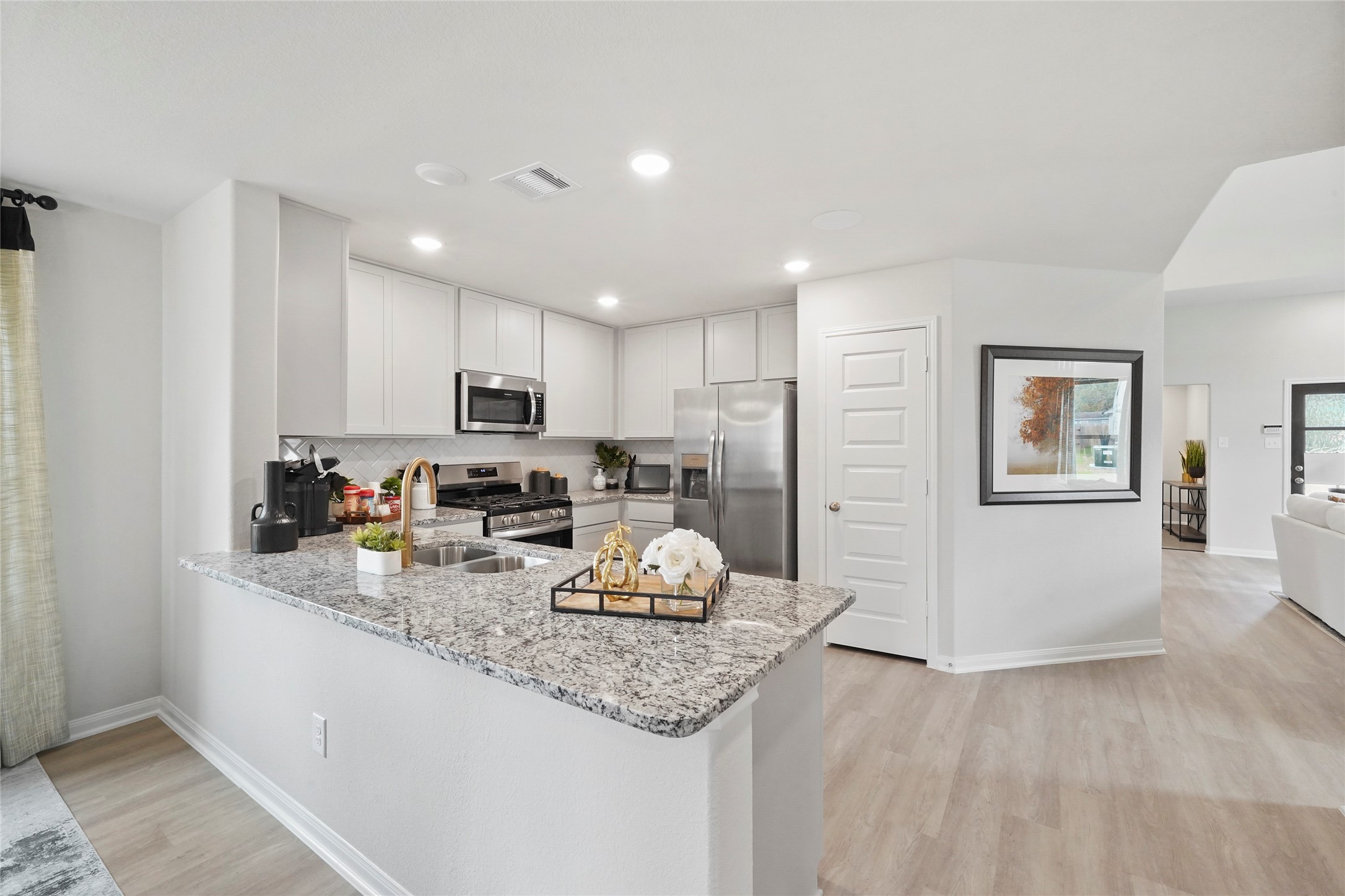 18782 Lucas Michael Way New Caney, TX 77357 - Photo 8 of 16 a kitchen with granite countertop cabinets and refrigerator
