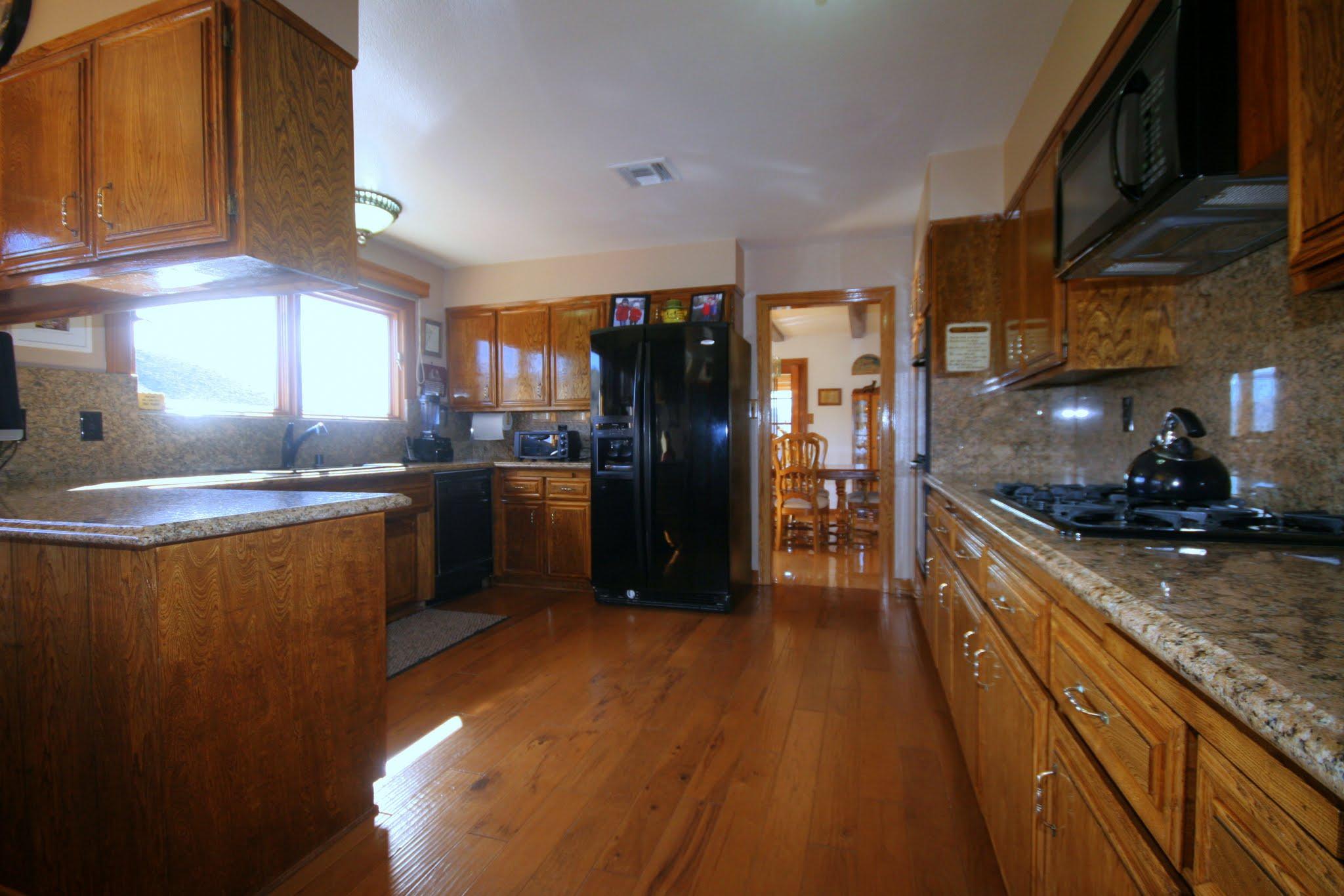 34421 Red Rover Mine Road Acton, CA 93510 - Photo 16 of 52 a kitchen with stainless steel appliances granite countertop a refrigerator a sink dishwasher a stove and a refrigerator