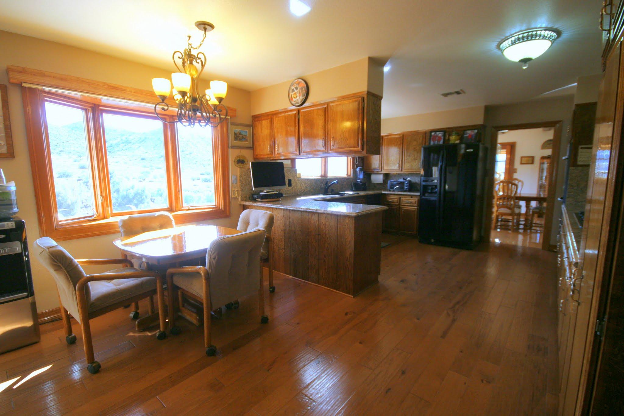 34421 Red Rover Mine Road Acton, CA 93510 - Photo 20 of 52 a view of a dining room with furniture a chandelier and wooden floor