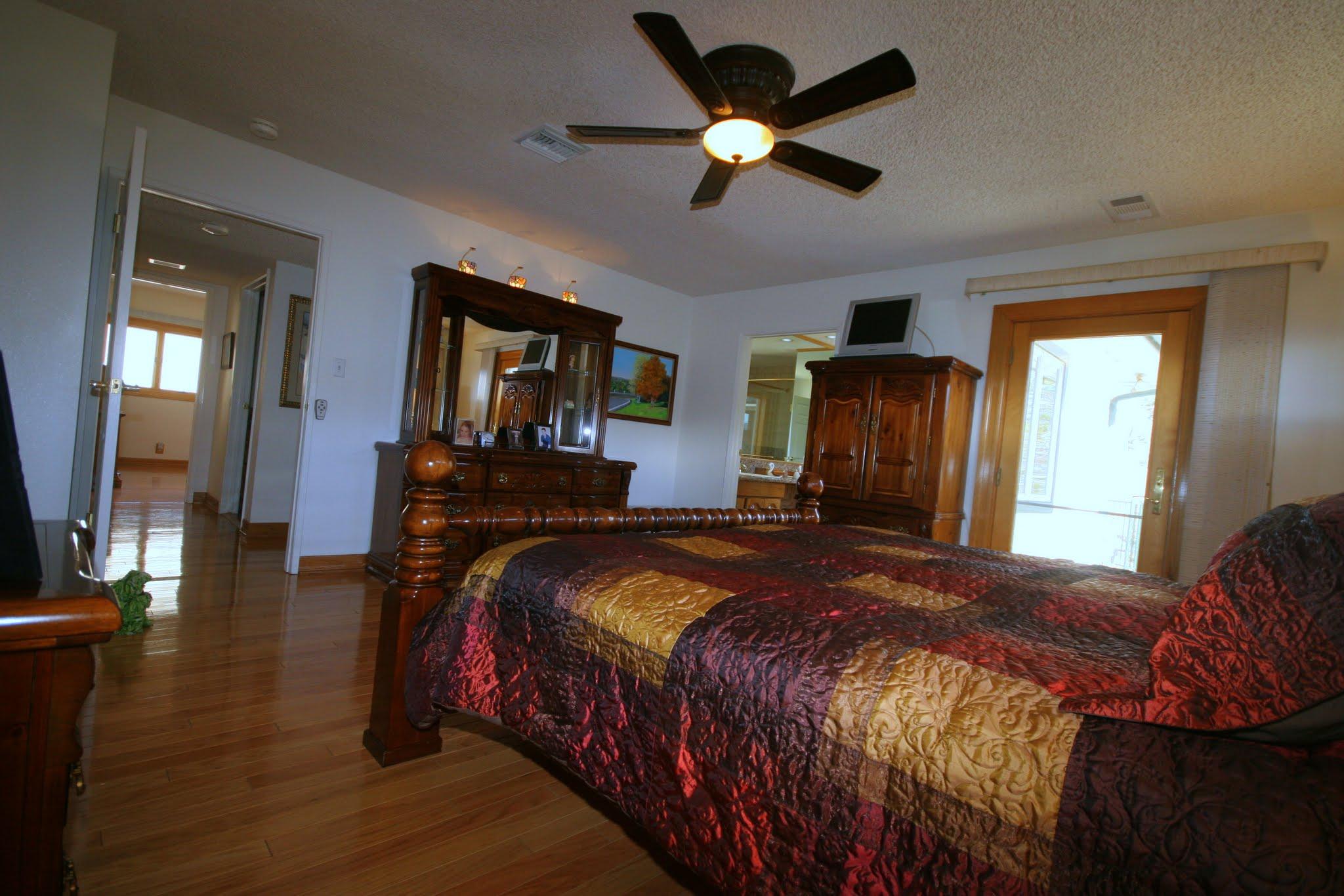 34421 Red Rover Mine Road Acton, CA 93510 - Photo 25 of 52 a bedroom with a bed and a chandelier