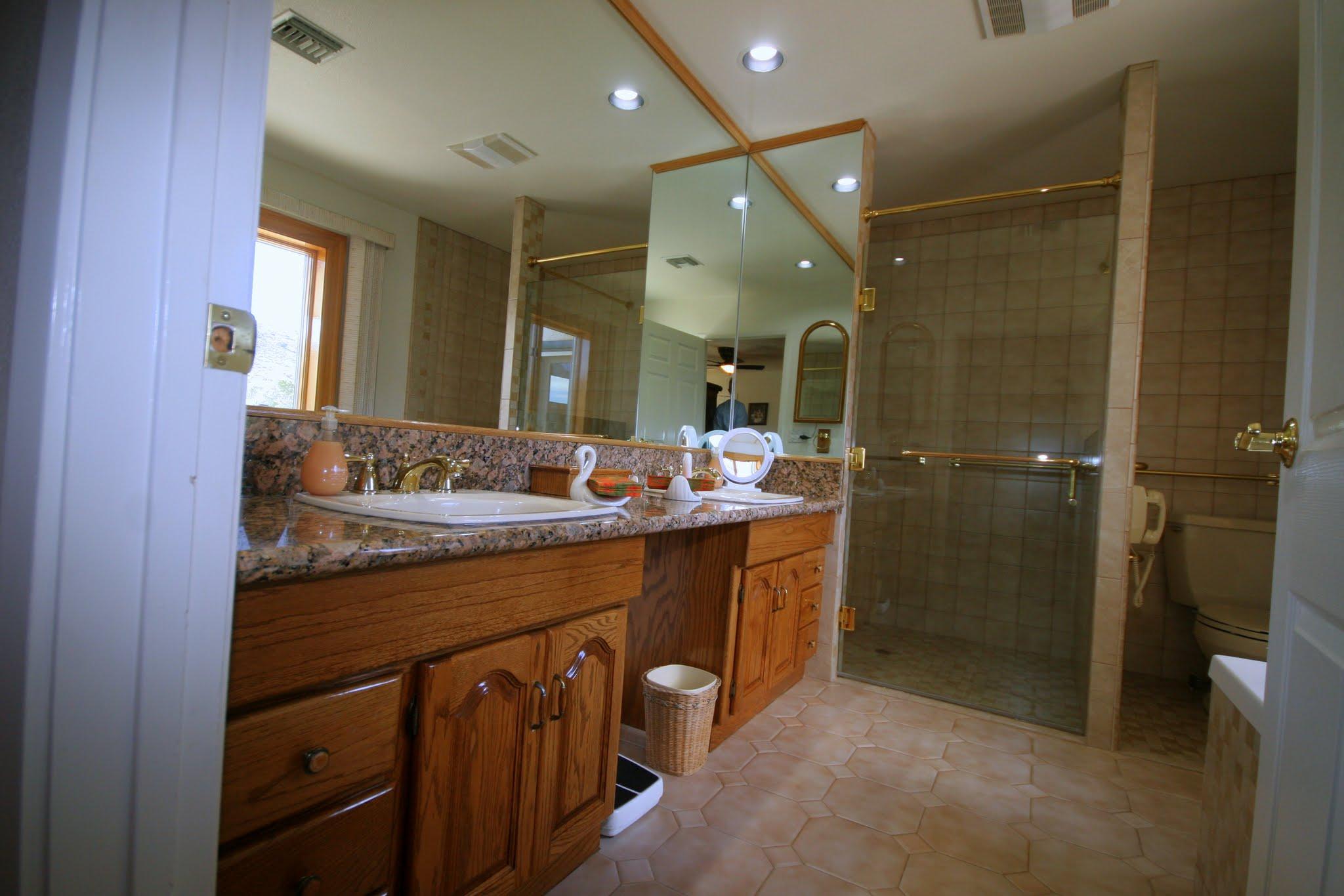 34421 Red Rover Mine Road Acton, CA 93510 - Photo 27 of 52 a bathroom with a double vanity sink and mirror