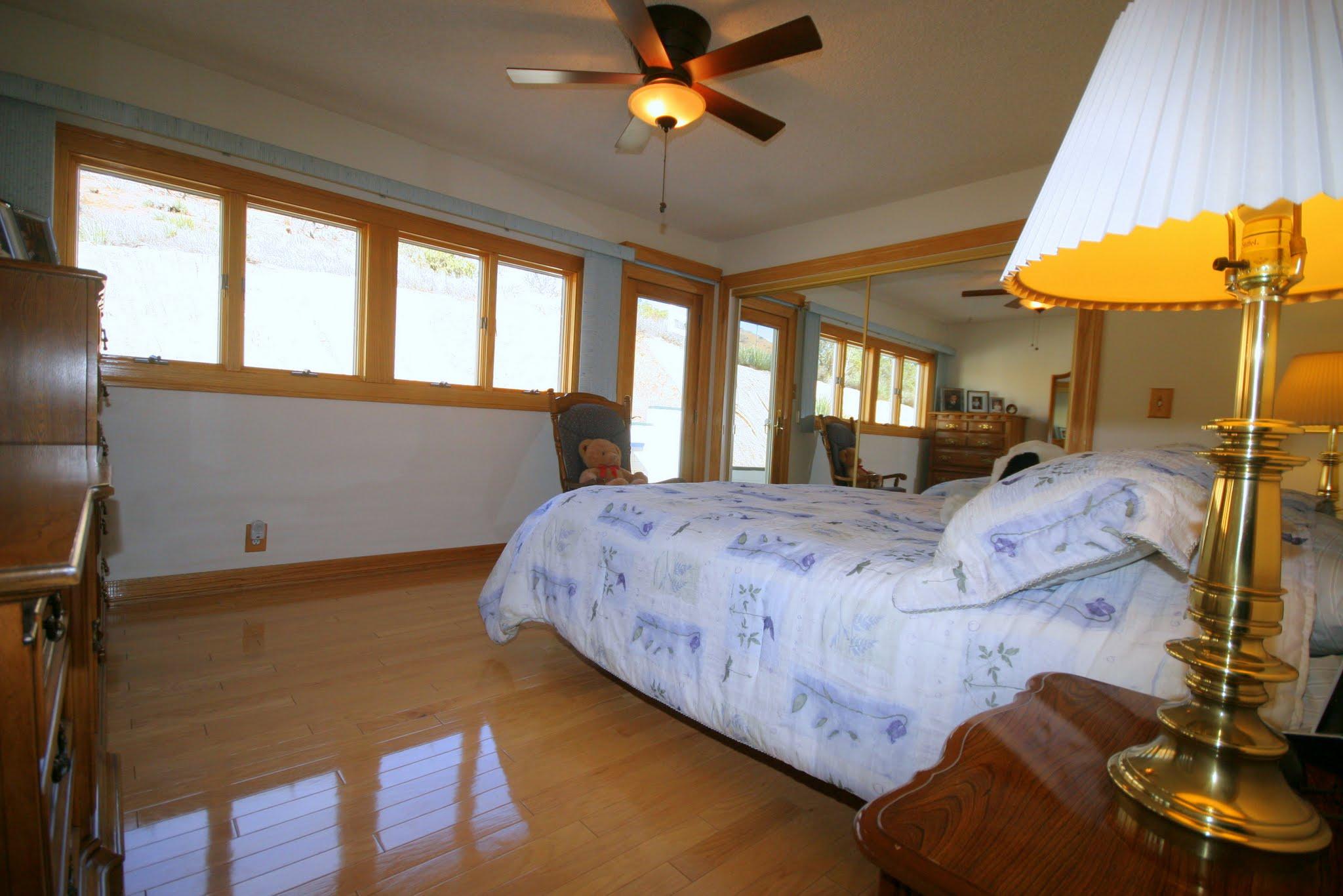 34421 Red Rover Mine Road Acton, CA 93510 - Photo 34 of 52 a bedroom with a bed a chandelier and a window