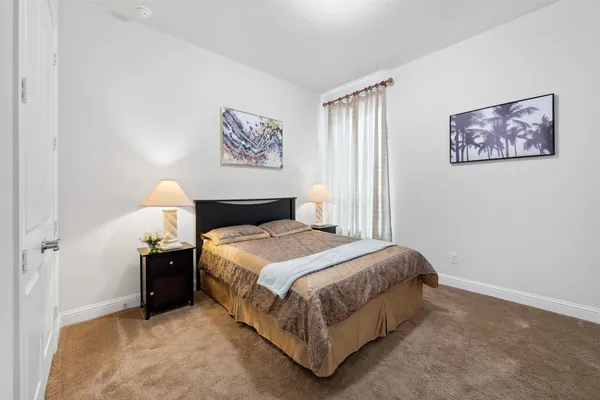 a bedroom with a bed and a night stand