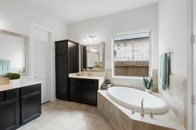 a bathroom with a double vanity sink mirror and shower