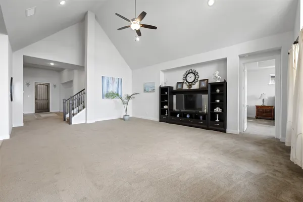 a view of a livingroom with furniture and a ceiling fan