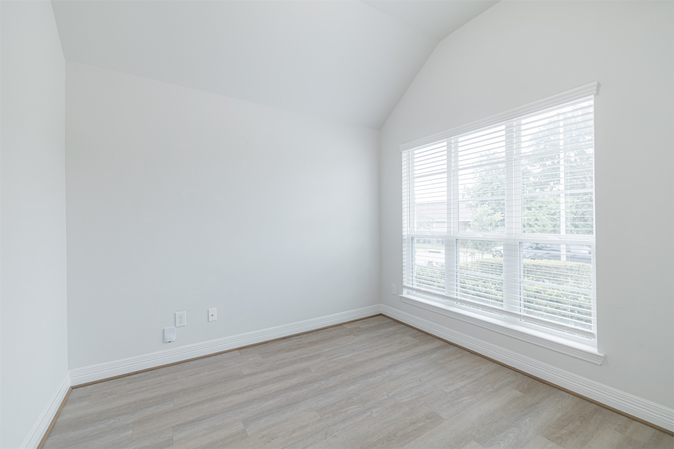 33118 School Hl Road Fulshear, TX 77441 - Photo 5 of 18 an empty room with wooden floor and windows