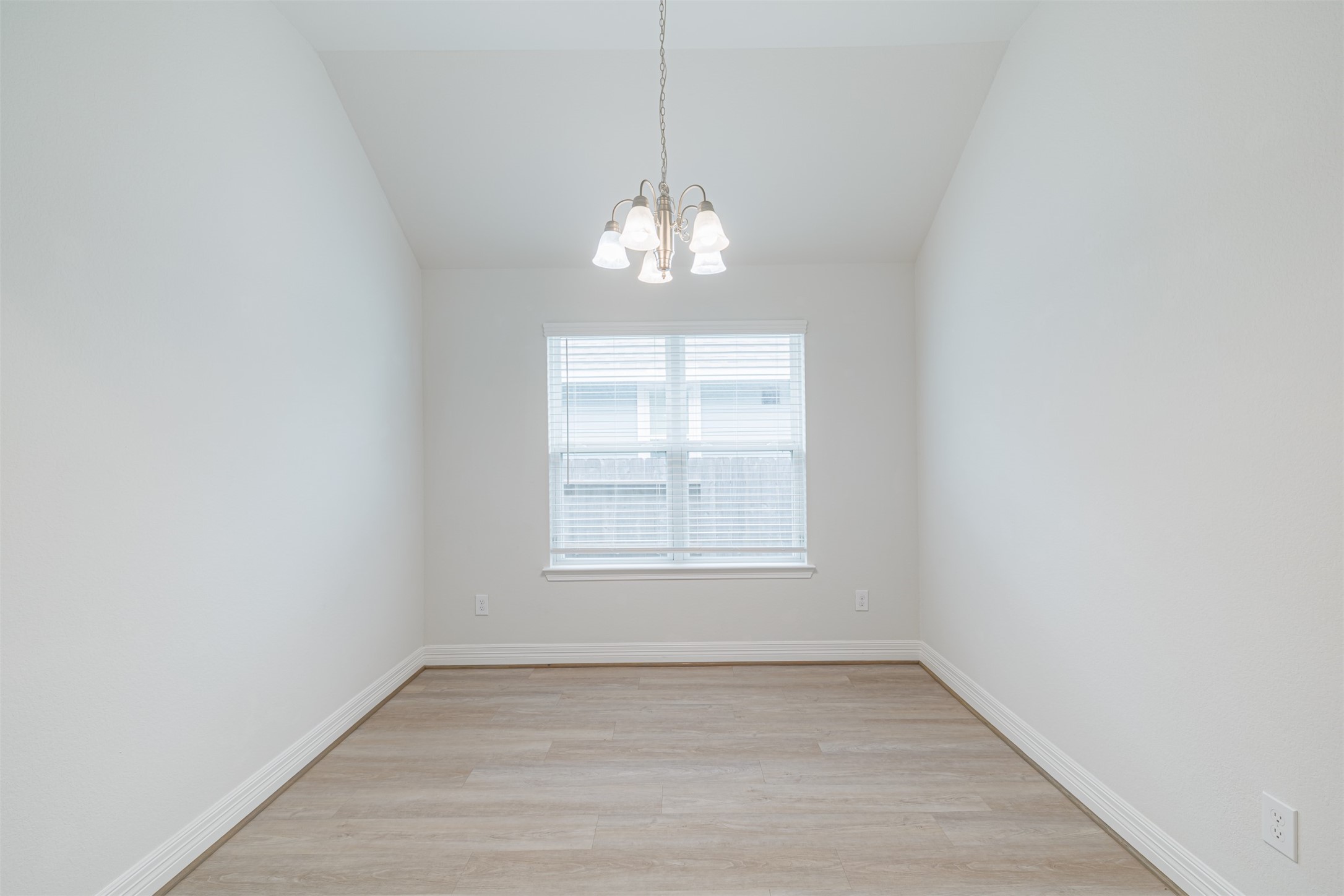 33118 School Hl Road Fulshear, TX 77441 - Photo 6 of 18 a view of an empty room with wooden floor and a window