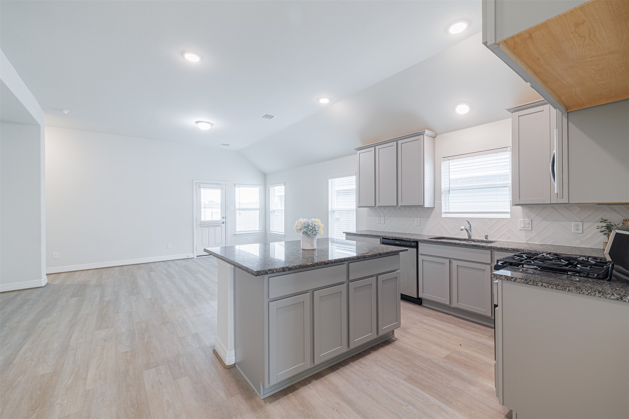 33118 School Hl Road Fulshear, TX 77441 - Photo 7 of 18 a kitchen with granite countertop a sink and cabinets