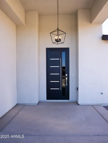 a view of a big room with wooden floor and windows