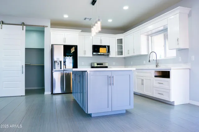 a kitchen with cabinets and stainless steel appliances