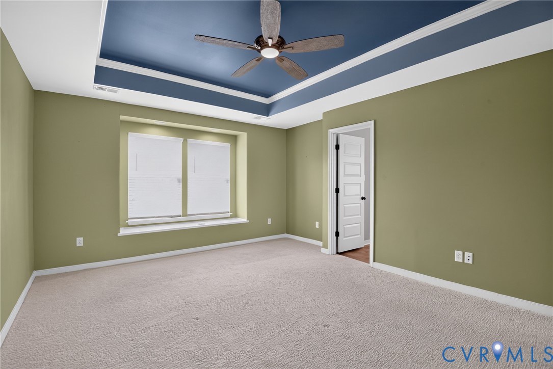 7825 Old Guild Road Richmond, VA 23237 - Photo 19 of 35 Spacious room featuring a tray ceiling with a ceil
