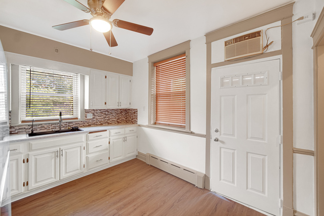 1007 South Austin Boulevard, Unit 1 Chicago, IL 60644 - Photo 12 of 15 a kitchen with granite countertop white cabinets and white appliances