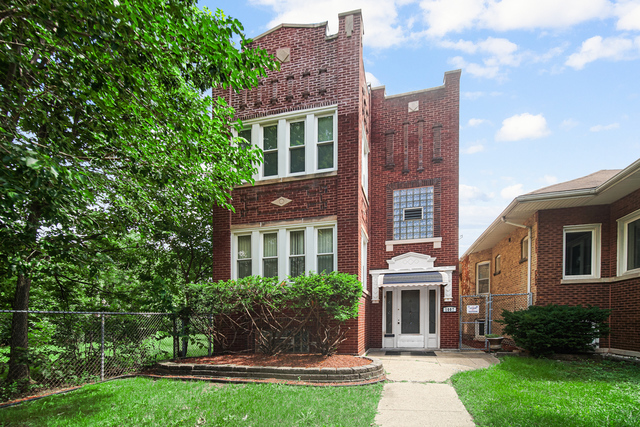 1007 South Austin Boulevard, Unit 1 Chicago, IL 60644 - Photo 2 of 15 a front view of a house with a yard