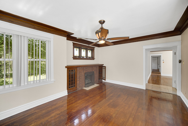 1007 South Austin Boulevard, Unit 1 Chicago, IL 60644 - Photo 6 of 15 a view of an empty room with wooden floor and a window