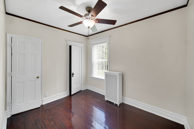 1007 South Austin Boulevard, Unit 1 Chicago, IL 60644 - Photo 9 of 15 an empty room with wooden floor and windows