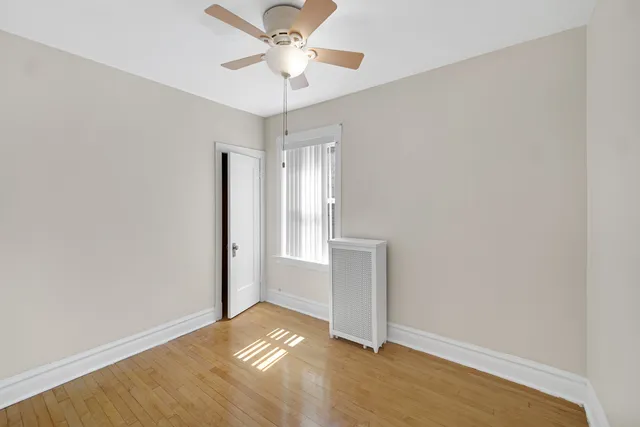 an empty room with a empty space and a ceiling fan