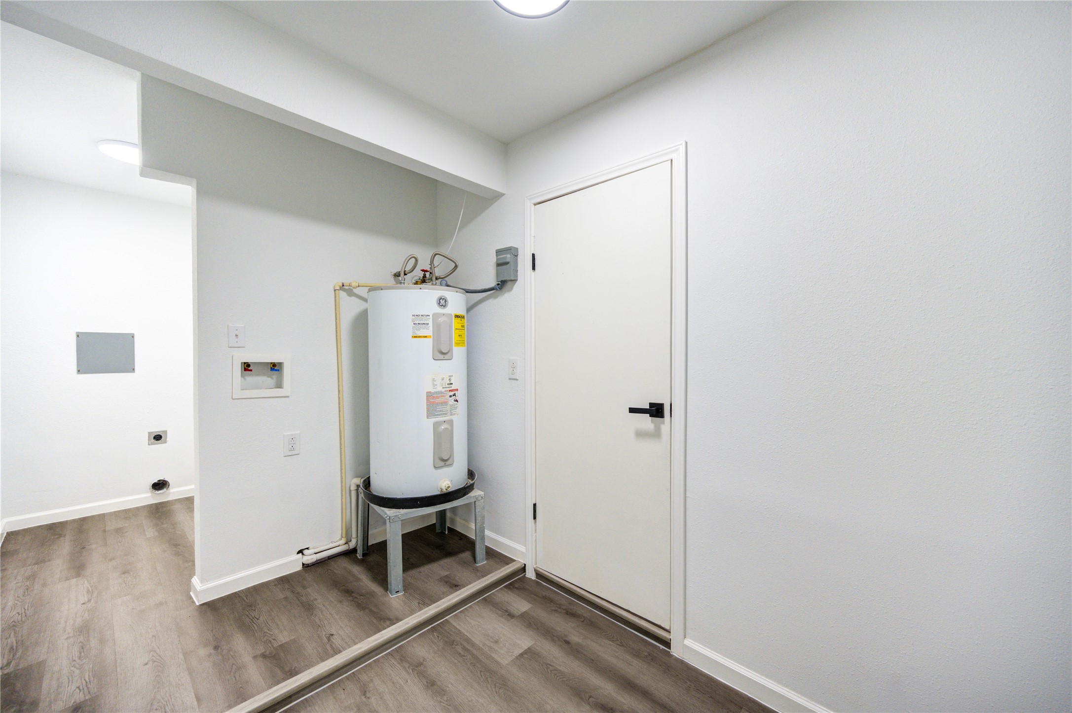 12127 Palmton Street Houston, TX 77034 - Photo 16 of 31 a view of a room with wooden floor and white cabinet