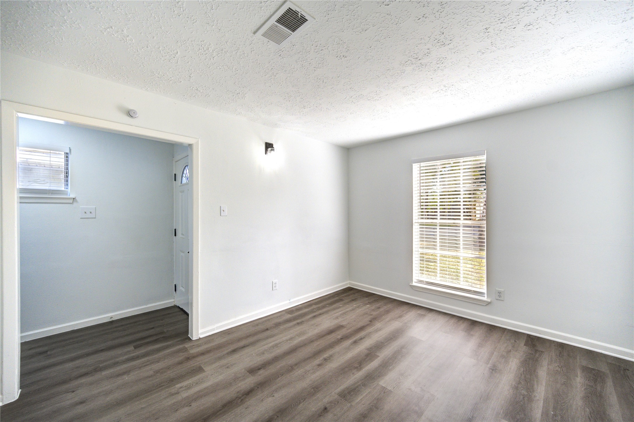 12127 Palmton Street Houston, TX 77034 - Photo 26 of 31 an empty room with wooden floor and windows