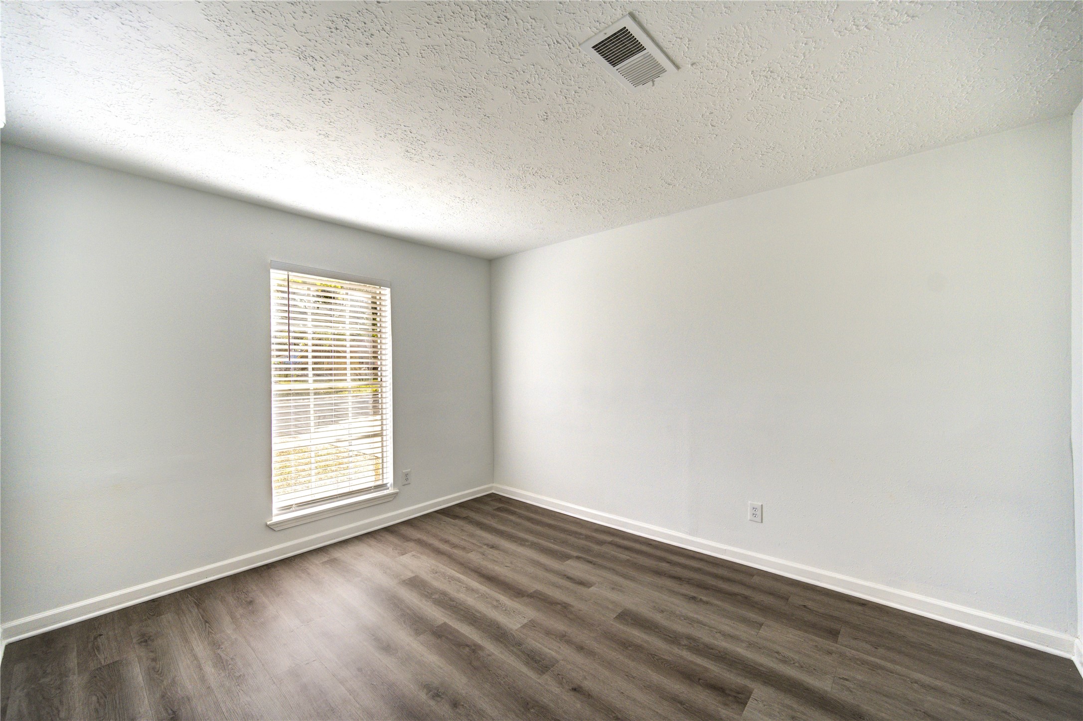 12127 Palmton Street Houston, TX 77034 - Photo 27 of 31 an empty room with wooden floor and windows
