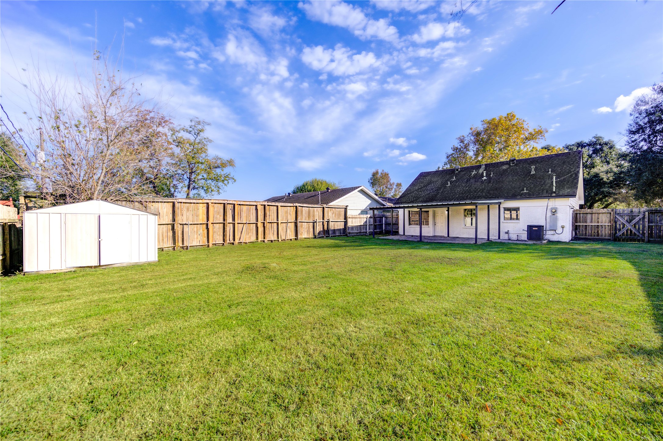 12127 Palmton Street Houston, TX 77034 - Photo 3 of 31 a view of a house with a big yard and large trees