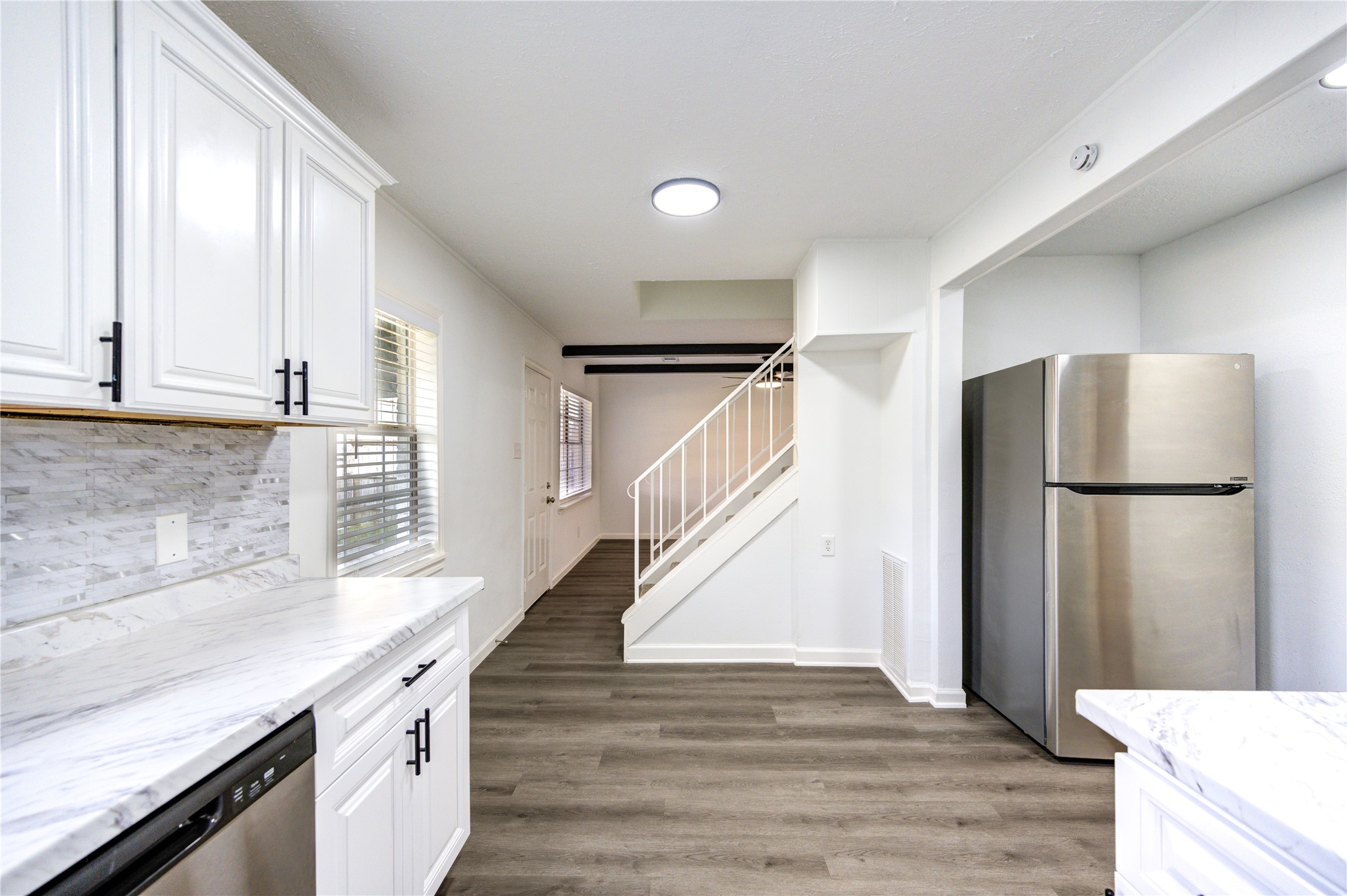 12127 Palmton Street Houston, TX 77034 - Photo 7 of 31 a kitchen with granite countertop a refrigerator and a sink