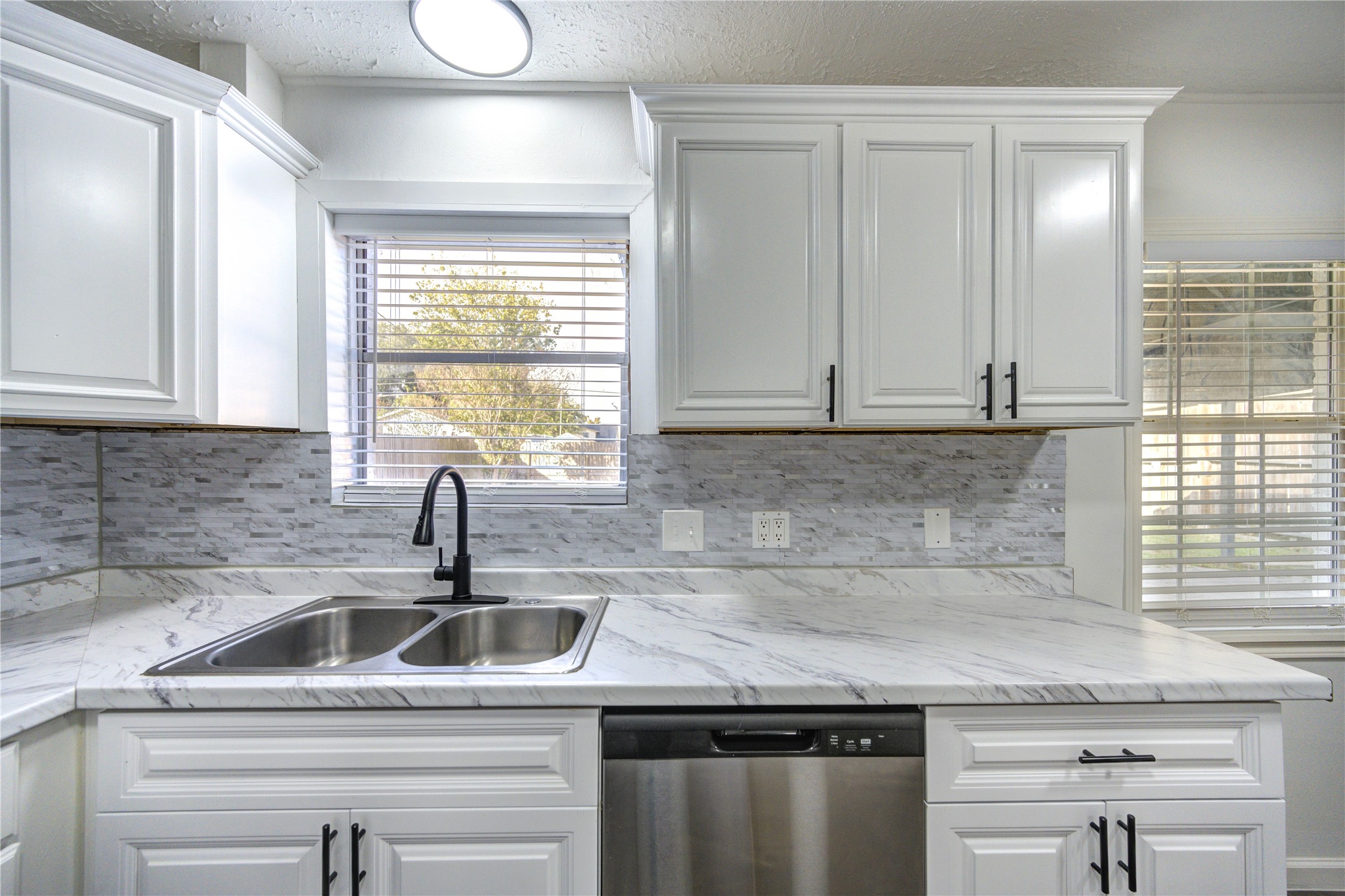 12127 Palmton Street Houston, TX 77034 - Photo 8 of 31 a kitchen with granite countertop a sink and a window