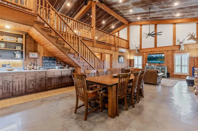 a kitchen with a table chairs stove and cabinets