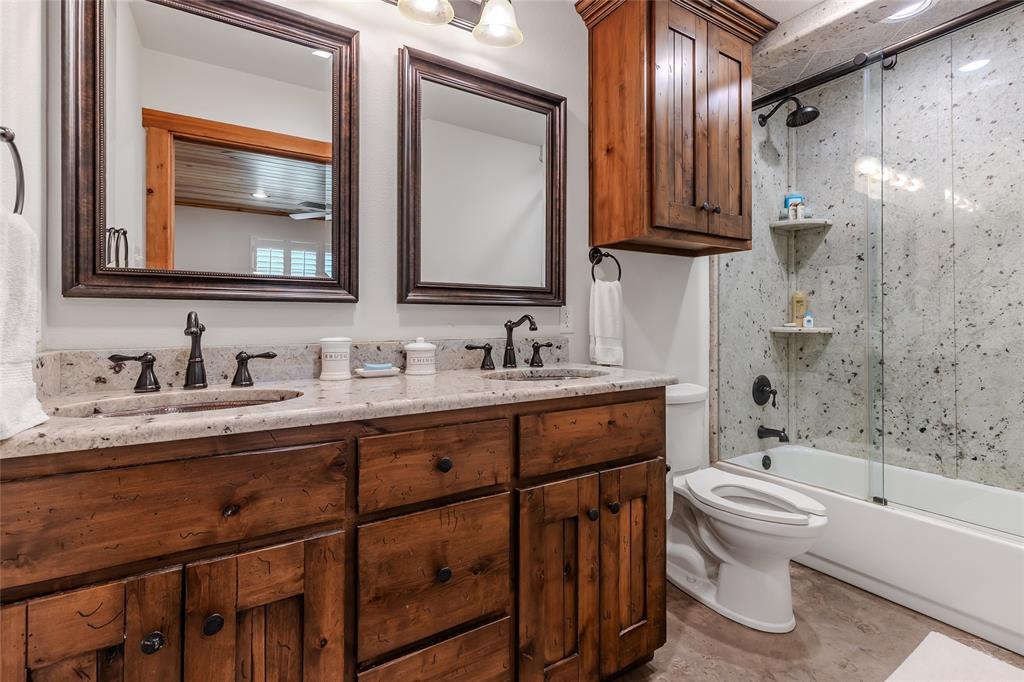 830 County Road 1439 Yantis, TX 75497 - Photo 18 of 40 Bathrooms feature double vanities, granite counters and shower/tub