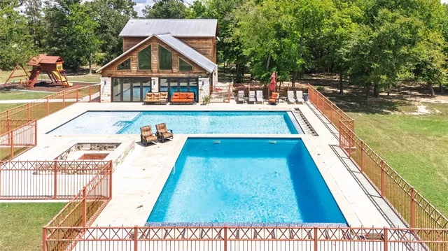 a view of hallway with stainless steel appliances a refrigerator and a window
