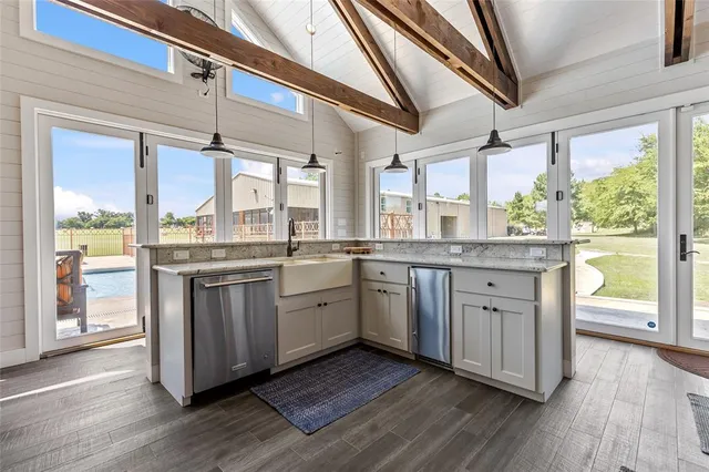 a living room with furniture and floor to ceiling windows