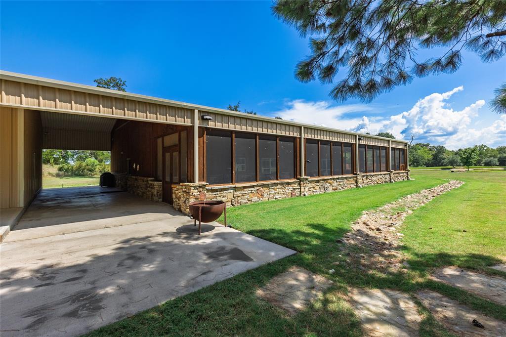 830 County Road 1439 Yantis, TX 75497 - Photo 31 of 40 Covered patio between barndo and storage barn