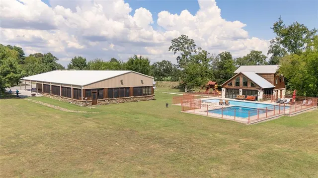 a house with swimming pool in front of it