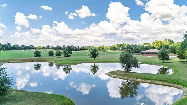 a view of a lake with houses in the back