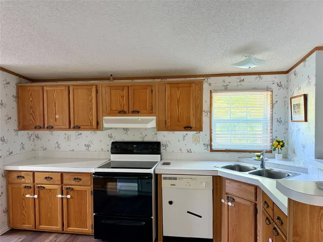 a kitchen with a sink stove and cabinets