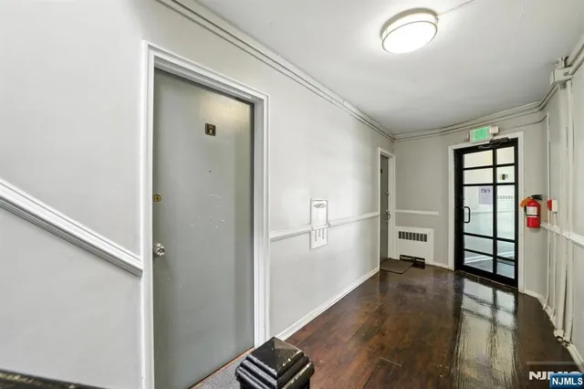 a view of hallway with wooden floor